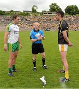 22 June 2014;  Donegal captain Michael Murphy, left,  and Antrim captain Niall McKeever tower over Referee Barry Cassidy ahead of the game. Ulster GAA Football Senior Championship, Semi-Final, Donegal v Antrim, St Tiernach's Park, Clones, Co. Monaghan. Picture credit: Oliver McVeigh / SPORTSFILE