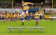 22 June 2014; The Clare captain Gary Brennan jumps onto the seat for the team photograph. Munster GAA Football Senior Championship, Semi-Final, Clare v Kerry, Cusack Park, Ennis, Co. Clare. Picture credit: Ray McManus / SPORTSFILE