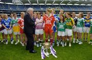 3 July 2006; An Taoiseach, Bertie Ahern TD, is greeted by Cork captain Juliette Murphy, in the presence of representatives from the rest of the 31 competing counties, on his arrival at the launch of the 2006 TG4 All-Ireland Ladies Football Championship. Croke Park, Dublin. Picture credit: Brendan Moran / SPORTSFILE