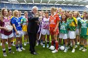 3 July 2006; An Taoiseach, Bertie Ahern TD, examines the Brendan Martin Cup, watched by Cork captain Juliette Murphy and Galway captain Lorna Joyce and representatives of the other 30 competing counties, at the launch of the 2006 TG4 All-Ireland Ladies Football Championship. Croke Park, Dublin. Picture credit: Brendan Moran / SPORTSFILE