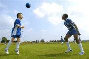 5 July 2006; Ryan Lee Cleary, age 9, from Kentstown, and Nonso Anny-Nzekwue, age 9, from Warrenstown, taking part at the Pepsi FAI Summer Soccer School at Blanchardstown IT. This particular camp was partially funded by various local groups in the area and the FAI. The Pepsi FAI Summer Soccer Schools run until the end of August in over 200 locations nationwide. See www.fai.ie for more details. Blanchardstown IT, Blanchardstown, Co. Dublin. Picture credit: Brian Lawless / SPORTSFILE