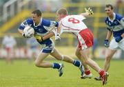 8 July 2006; Gary Kavanagh, Laois, is tackled by Kevin Hughes, Tyrone. Bank of Ireland All-Ireland Senior Football Championship Qualifier, Round 2, Laois v Tyrone, O'Moore Park, Portlaoise, Co. Laois. Picture credit: Brendan Moran / SPORTSFILE