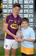 25 June 2014; Wexford's Conor McDonald is presented with the Player of the Match Award by 10 year old Oisin Carroll, from Ballycumber, Co. Offaly. Bord Gáis Energy Leinster GAA Hurling Under 21 Championship, Semi-Final, Wexford v Offaly, Wexford Park, Wexford. Picture credit: Matt Browne / SPORTSFILE