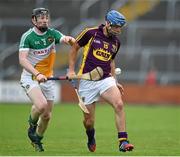 25 June 2014; Garry Moore, Wexford, in action against Niall Wynne, Offaly. Bord Gáis Energy Leinster GAA Hurling Under 21 Championship, Semi-Final, Wexford v Offaly, Wexford Park, Wexford. Picture credit: Matt Browne / SPORTSFILE