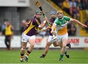25 June 2014; Kevin Foley, Wexford, in action against Sean Gerdiner, Offaly. Bord Gáis Energy Leinster GAA Hurling Under 21 Championship, Semi-Final, Wexford v Offaly, Wexford Park, Wexford. Picture credit: Matt Browne / SPORTSFILE