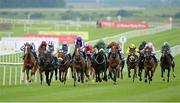 27 June 2014: Woods, fifth from left, with Joseph O'Brien up, breaks away from the field on their way to winning the Tom Crean's Irish Lager European Breeders Fund Fillies Maiden. Curragh Racecourse, The Curragh, Co. Kildare. Picture credit: Barry Cregg / SPORTSFILE