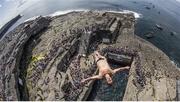 28 June 2014; Cyrille Oumedjkane dives from the 28 metre platform during the seeding round of the third stop of the Red Bull Cliff Diving World Series. Inis Mor, Aran Islands, Co. Galway. Picture credit: Romina Amato / SPORTSFILE