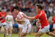 28 June 2014; Darren McCurry, Tyrone, in action against Padraig Rath, Louth. GAA Football All Ireland Senior Championship, Round 1B, Tyrone v Louth, Healy Park, Omagh, Co. Tyrone. Picture credit: Oliver McVeigh / SPORTSFILE