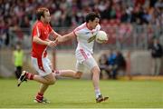 28 June 2014; Mattie Donnelly, Tyrone, in action against Mick Fanning, Louth. GAA Football All Ireland Senior Championship, Round 1B, Tyrone v Louth, Healy Park, Omagh, Co. Tyrone. Picture credit: Oliver McVeigh / SPORTSFILE