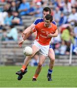28 June 2014; Shane Conlon, Armagh, in action against Barry Kerr, Monaghan. Electric Ireland Ulster GAA Football Minor Championship Semi-Final, St Tiernach's Park, Clones, Co. Monaghan. Picture credit: Ramsey Cardy / SPORTSFILE