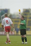 8 July 2006; Kevin Hughes, Tyrone, is shown a yellow card by referee John Geaney. Bank of Ireland All-Ireland Senior Football Championship Qualifier, Round 2, Laois v Tyrone, O'Moore Park, Portlaoise, Co. Laois. Picture credit: Brendan Moran / SPORTSFILE