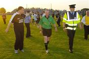 15 July 2006; Referee Michael Ryan is escorted off the pitch by a member of an Garda Siochana while being confronted by Sligo managerTommy Breheny. Bank of Ireland All-Ireland Senior Football Championship Qualifier, Round 3, Sligo v Westmeath, Markievicz Park, Sligo. Picture credit: Pat Murphy / SPORTSFILE