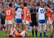 28 June 2014; Referee Joe McQuillan awards Monaghan's Conor McManus, 15, a black card after an incident with Armagh's Finnian Moriarty, below. Ulster GAA Football Senior Championship, Semi-Final, Armagh v Monaghan, St Tiernach's Park, Clones, Co. Monaghan. Picture credit: Ramsey Cardy / SPORTSFILE