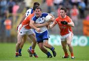 28 June 2014; Padraig Donaghy, Monaghan, is tackled by Aidan Forker, left, and Tony Kernan, Armagh. Ulster GAA Football Senior Championship, Semi-Final, Armagh v Monaghan, St Tiernach's Park, Clones, Co. Monaghan. Picture credit: Brendan Moran / SPORTSFILE