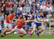 28 June 2014; Kieran Hughes, Monaghan, in action against Finnian Moriarty, left, and Charlie Vernon, Armagh. Ulster GAA Football Senior Championship, Semi-Final, Armagh v Monaghan, St Tiernach's Park, Clones, Co. Monaghan. Picture credit: Ramsey Cardy / SPORTSFILE