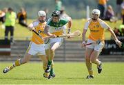 29 June 2014: Conor Mahon, Offaly, in action against Neal McAuley and Conor McKinley, Antrim. GAA Hurling All-Ireland Senior Championship, Round 1, Antrim v Offaly, Ballycastle, Co. Antrim. Picture credit: Oliver McVeigh / SPORTSFILE