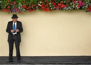 29 June 2014: A racegoer looking up his card ahead of the Irish Stallion Farms Eiropean Breeders Fund 'Ragusa' Handicap of €50,000. Curragh Racecourse, The Curragh, Co. Kildare. Picture credit: Barry Cregg / SPORTSFILE