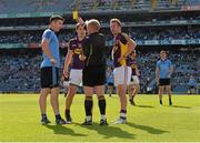 29 June 2014: Referee Ciaran Branagan issues a yellow card to Michael Darragh MacAuley, Dublin, and to Wexford players Ciaran Lyng and PJ Banville late in the game. Leinster GAA Football Senior Championship, Semi-Final, Dublin v Wexford, Croke Park, Dublin. Picture credit: Ray McManus / SPORTSFILE
