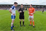 28 June 2014; Referee Joe McQuillan performs the pre-match coin toss in the company of Monaghan captain Conor McManus and Armagh captain Ciaran McKeever. Ulster GAA Football Senior Championship, Semi-Final, Armagh v Monaghan, St Tiernach's Park, Clones, Co. Monaghan. Picture credit: Ramsey Cardy / SPORTSFILE