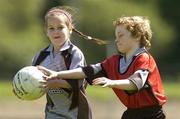 13 July 2006; Kate Gaskin, aged 8, and Cian Windsor, aged 8, from Roundwood, in action at the Wicklow Cul Camp. The GAA Vhi Cul Camps have been extremely popular to date and are expected to attract a record 75,000 children over the summer months. The camps run through til August 25th. Roundwood GAA Grounds, Roundwood, Co. Wicklow. Picture credit: Matt Browne / SPORTSFILE