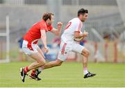 28 June 2014; Emmett McKenna, Tyrone, in action against Mick Fanning, Louth. GAA Football All Ireland Senior Championship, Round 1B, Tyrone v Louth, Healy Park, Omagh, Co. Tyrone. Picture credit: Oliver McVeigh / SPORTSFILE