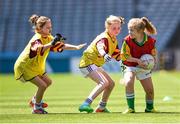 30 June 2014: Ally Brennan, Ballylinan, Laois, is tackled by Emma Hoey and Ciara Hackett, left, St. Maurs, Dublin, during the Gaelic4Girls National Blitz Day in a sun soaked Croke Park. The LGFA also announced their official new football boot. The vibrant pink football boots are on sale through the LGFA website and cost only €30 with clubs receiving 10% cashback on every order over 24 pairs. The new boots are produced by Kerry based and Irish owned company, RClub Sports. Picture credit: Stephen McCarthy / SPORTSFILE