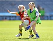30 June 2014: Erin Kelly, Warrenpoint, Down, is tackled by Saoirse O'Keefe, Gaultier, Waterford, right, during the Gaelic4Girls National Blitz Day in sun soaked Croke Park. The LGFA also announced their official new football boot. The vibrant pink football boots are on sale through the LGFA website and cost only €30 with clubs receiving 10% cashback on every order over 24 pairs. The new boots are produced by Kerry based and Irish owned company, RClub Sports. Picture credit: Stephen McCarthy / SPORTSFILE
