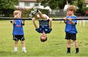 2 July 2014; Participants, from left, Johnny Woods, left, aged 6 from Rathgar, Dublin, Andrew Norse, aged 7, from Blackrock, Dublin, and Eoin McCarthy, right, aged 6, from Merrion Road, Dublin, fill in the time in between activities  during the Herald Leinster Rugby Summer Camps in Old Belvedere RFC, Donnybrook, Dublin. Picture credit: Barry Cregg / SPORTSFILE