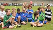2 July 2014; Children put to hands up to ask Leinster's Kevin McLaughlin and Cian Healy questions during the Herald Leinster Rugby Summer Camps in Old Belvedere RFC, Donnybrook, Dublin. Picture credit: Barry Cregg / SPORTSFILE