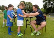 2 July 2014; Tristan Boland, aged 6, from Ballsbridge, Dublin, gets his jersy signed by Leinster's Kevin McLaughlin during the Herald Leinster Rugby Summer Camps in Old Belvedere RFC, Donnybrook, Dublin. Picture credit: Barry Cregg / SPORTSFILE