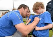 2 July 2014; Alistair Verdon aged 8, from Glasnevin, Dublin, gets his t-shirt signed by Leinster's Cian Healy during the Herald Leinster Rugby Summer Camps in Old Belvedere RFC, Donnybrook, Dublin. Picture credit: Barry Cregg / SPORTSFILE