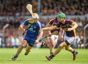 5 July 2014;  Conor McGrath, Clare, in action against Matthew O'Hanlon, Wexford. GAA Hurling All-Ireland Senior Championship, Round 1, Clare v Wexford, Cusack Park, Ennis, Co. Clare. Picture credit: Ray McManus / SPORTSFILE