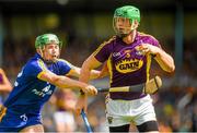5 July 2014; Matthew O'Hanlon, Wexford, is tackled by Cathal McInerney, Clare. GAA Hurling All-Ireland Senior Championship, Round 1, Clare v Wexford, Cusack Park, Ennis, Co. Clare. Picture credit: Ray McManus / SPORTSFILE