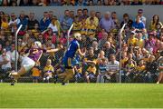 5 July 2014;  Conor McGrath, Clare, scores a point despite being put under pressure by Liam Ryan, Wexford. GAA Hurling All-Ireland Senior Championship, Round 1, Clare v Wexford, Cusack Park, Ennis, Co. Clare. Picture credit: Ray McManus / SPORTSFILE