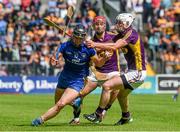 5 July 2014;  John Conlon, Clare, in action against Ciarán Kenny, right, and Eoin Moore, Wexford. GAA Hurling All-Ireland Senior Championship, Round 1, Clare v Wexford, Cusack Park, Ennis, Co. Clare. Picture credit: Ray McManus / SPORTSFILE