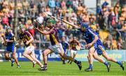 5 July 2014; Keith Rossiter, Wexford, clears under pressure from Pádraic Collins, Clare. GAA Hurling All-Ireland Senior Championship, Round 1, Clare v Wexford, Cusack Park, Ennis, Co. Clare. Picture credit: Ray McManus / SPORTSFILE