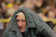 22 July 2006; A supporter shelters from the rain. Guinness All-Ireland Senior Hurling Championship Quarter-Final, Cork v Limerick, Semple Stadium, Thurles, Co. Tipperary. Picture credit: Damien Eagers / SPORTSFILE