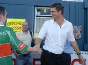 24 July 2006; Sunderland Chairman Niall Quinn is welcomed to Tolka by a Mayo Gaelic Football fan as he makes his way to the stand. Pre-season Friendly, Shelbourne v Sunderland, Tolka Park, Dublin. Picture credit: Damien Eagers / SPORTSFILE