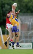 25 July 2006; Padraig Neylon and Ger Quinlan, Clare, contest a high ball with Martin Farrelly, Louth. Tommy Murphy Cup, Round 1, Clare v Louth, Cusack Park, Ennis, Co. Clare. Picture credit: Kieran Clancy / SPORTSFILE