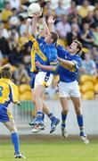 29 July 2006; Kevin Higgins, Roscommon, takes the ball from Paddy Murphy and Philip Donnellan, right, Tipperary. ESB All-Ireland Minor Football Championship Quarter-Final, Roscommon v Tipperary, O'Connor Park, Tullamore, Co. Offaly. Picture credit; Matt Browne / SPORTSFILE