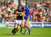 5 July 2014; PJ Nolan, Wexford, is tackled by Colm Galvin, Clare. GAA Hurling All-Ireland Senior Championship, Round 1, Clare v Wexford, Cusack Park, Ennis, Co. Clare. Picture credit: Ray McManus / SPORTSFILE
