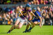 5 July 2014; Jack Guiney, Wexford, is tackled by David McInerney, Clare. GAA Hurling All-Ireland Senior Championship, Round 1, Clare v Wexford, Cusack Park, Ennis, Co. Clare. Picture credit: Ray McManus / SPORTSFILE