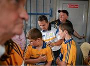 5 July 2014; Clare manager Davy Fitzgerald signs the shirt of Clare supporter Eoghan Killeen, aged 11, from Inch, Co. Clare. GAA Hurling All-Ireland Senior Championship, Round 1, Clare v Wexford, Cusack Park, Ennis, Co. Clare. Picture credit: Ray McManus / SPORTSFILE