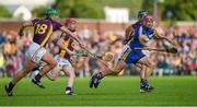 5 July 2014; PJ Nolan, supported by Willie Devereux and Richie Kehoe, left, knocks the sliotar away from Clare's Davy O'Halloran. GAA Hurling All-Ireland Senior Championship, Round 1, Clare v Wexford, Cusack Park, Ennis, Co. Clare. Picture credit: Ray McManus / SPORTSFILE