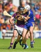 5 July 2014; PJ Nolan, Wexford, in action against Patrick O'Connor, Clare. GAA Hurling All-Ireland Senior Championship, Round 1, Clare v Wexford, Cusack Park, Ennis, Co. Clare. Picture credit: Ray McManus / SPORTSFILE