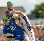 5 July 2014; Wexford goalkeeper Mark Fanning, supported by his captain Matthew O'Hanlon, tries to clear under pressure from Clare's Cathal McInerney. GAA Hurling All-Ireland Senior Championship, Round 1, Clare v Wexford, Cusack Park, Ennis, Co. Clare. Picture credit: Ray McManus / SPORTSFILE