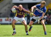 6 July 2014; James Holmes, Wexford, in action against Denis Booth, Laois. GAA Football All Ireland Senior Championship, Round 2A, Wexford v Laois, Wexford Park, Wexford. Picture credit: Barry Cregg / SPORTSFILE