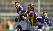 6 July 2014; Billy Sheehan, Laois, in action against Michael Furlong, Wexford.  GAA Football All Ireland Senior Championship, Round 2a, Wexford v Laois, Wexford Park, Wexford. Picture credit: Barry Cregg / SPORTSFILE