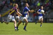 6 July 2014; Niall Donoher, Laois, in action against Kevin O'Grady, Wexford.  GAA Football All Ireland Senior Championship, Round 2a, Wexford v Laois, Wexford Park, Wexford. Picture credit: Barry Cregg / SPORTSFILE