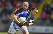 6 July 2014; Conor Meredith, Laois, in action against James Holmes, Wexford.  GAA Football All Ireland Senior Championship, Round 2A, Wexford v Laois, Wexford Park, Wexford. Picture credit: Barry Cregg / SPORTSFILE